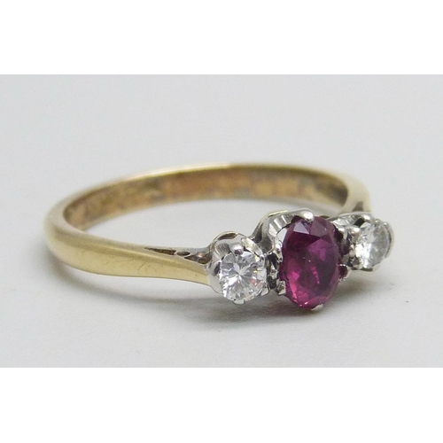 1147 - An 18ct gold and platinum ring set with a ruby and two diamonds, 2.5g, L