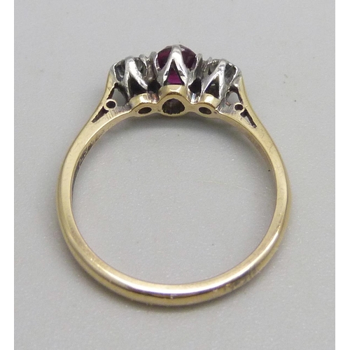 1147 - An 18ct gold and platinum ring set with a ruby and two diamonds, 2.5g, L