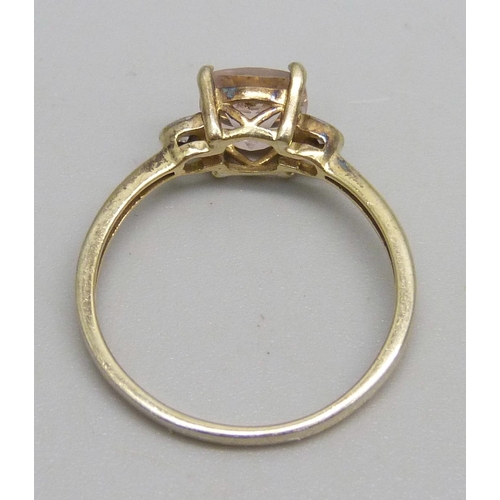 1153 - A silver gilt ring set with a pink stone and two small diamonds, R