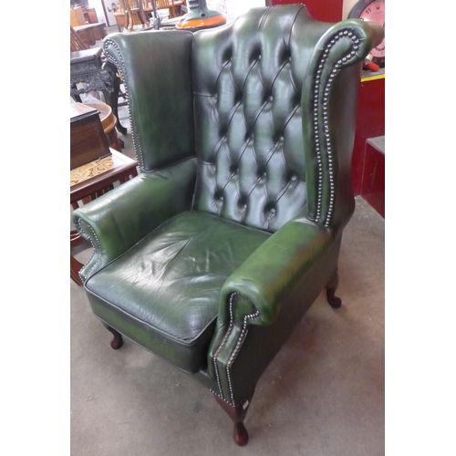 102 - A green leather Chesterfield wingback armchair