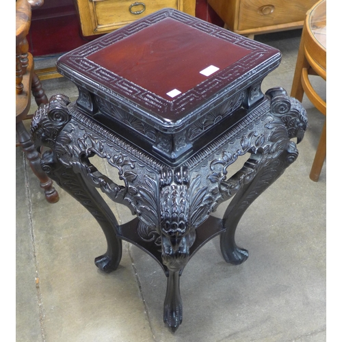 104 - A Chinese carved ebonised jardiniere stand