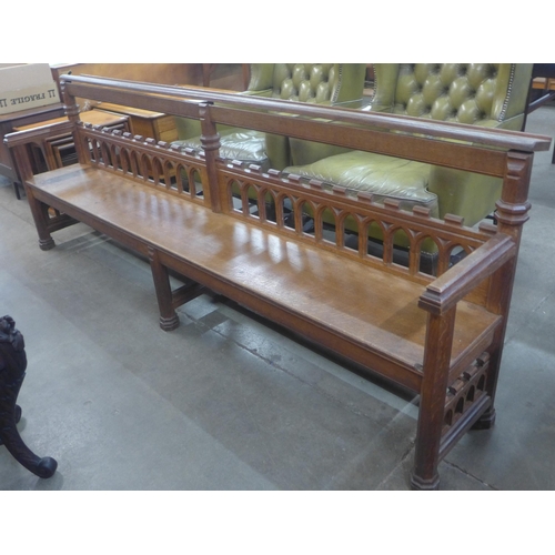 112A - A Victorian Gothic Revival carved oak hall bench