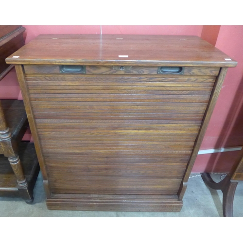 114 - An early 20th Century oak tambour front fitted cabinet