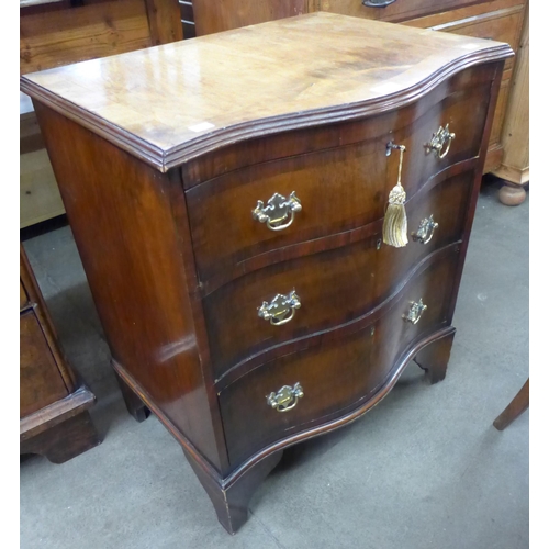 125 - A George III style mahogany serpentine bachelor's chest of drawers