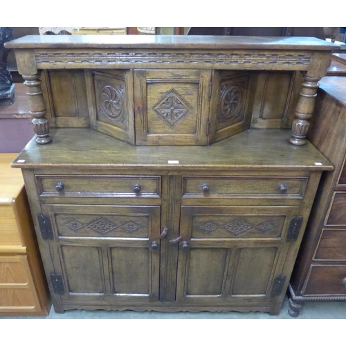 130 - A 17th Century style carved oak court cupboard