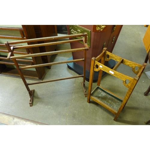 136 - An Arts and Crafts oak stick stand and a mahogany towel rail