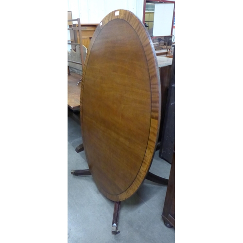 138 - A 19th Century mahogany oval tilt-top dining table, Waites of Chesterfield