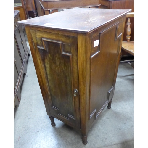 141 - An early 20th Century oak geometric moulded pot cupboard