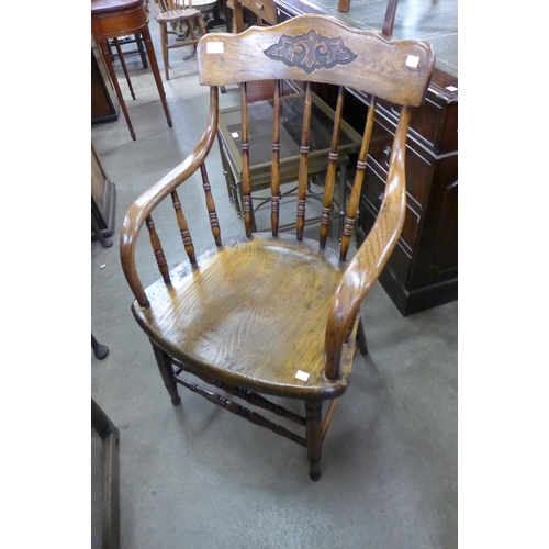 159 - An early 20th Century American elm elbow chair