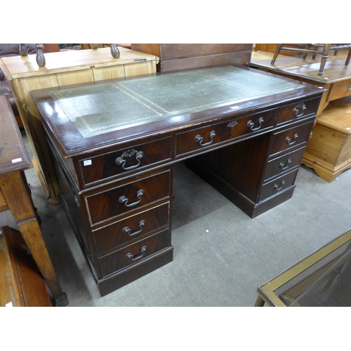 162 - A mahogany and green leather topped pedestal desk