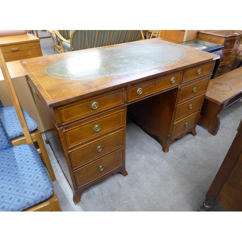 167 - A George III style inlaid yew wood and green leather topped pedestal desk