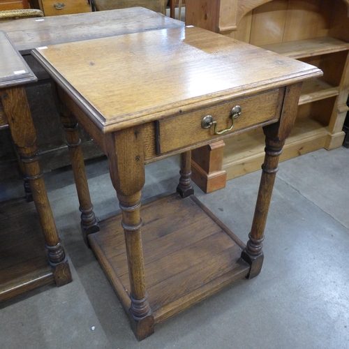 176 - A George III style oak single drawer lamp table