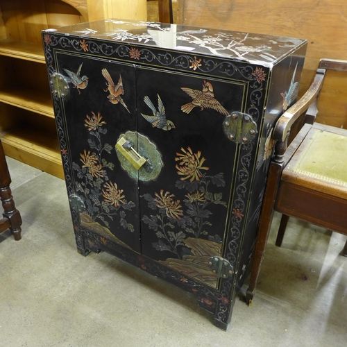 178 - A Chinese black lacquered chinoiserie two door cabinet