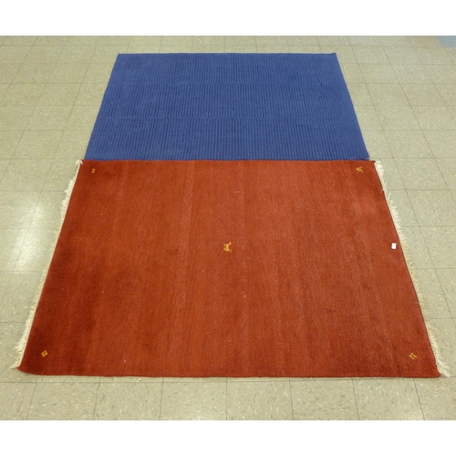 216 - A red ground rug and a blue ground rug