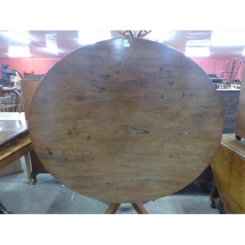 256 - A Regency mahogany oval tilt-top centre table