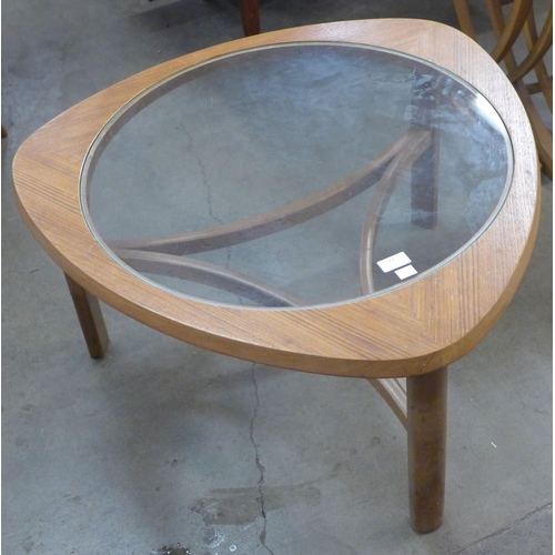 27 - A Nathan teak and glass topped triangular coffee table