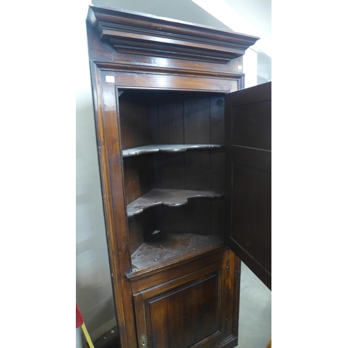 273 - A George III stained pine freestanding corner cupboard