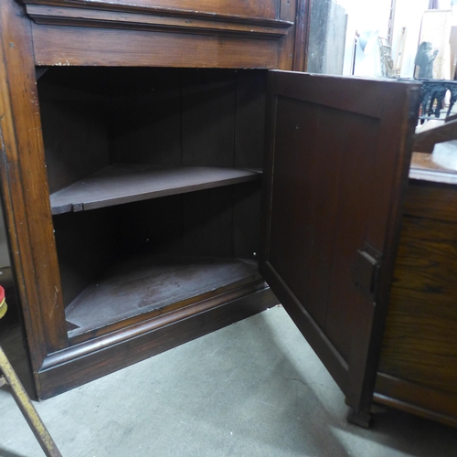 273 - A George III stained pine freestanding corner cupboard