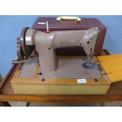 294 - A cased Singer sewing machine, with accessories