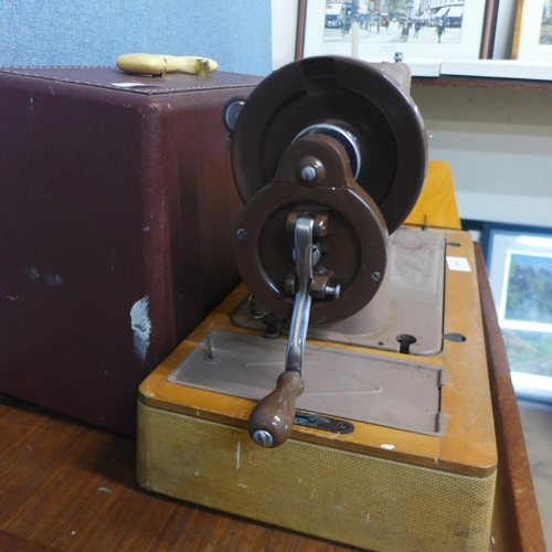 294 - A cased Singer sewing machine, with accessories