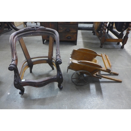 296 - A Victorian style child's carved mahogany chair frame and a vintage Tri-ang toy wheelbarrow