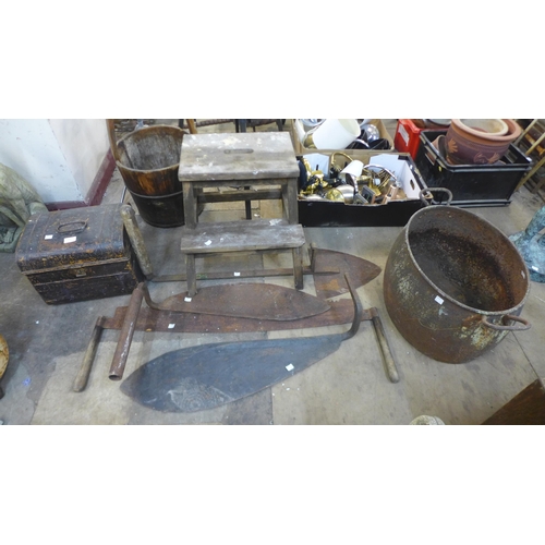 310 - A cast iron cauldron, a tin trunk, tools, etc.