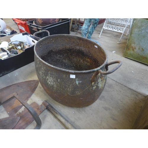 310 - A cast iron cauldron, a tin trunk, tools, etc.