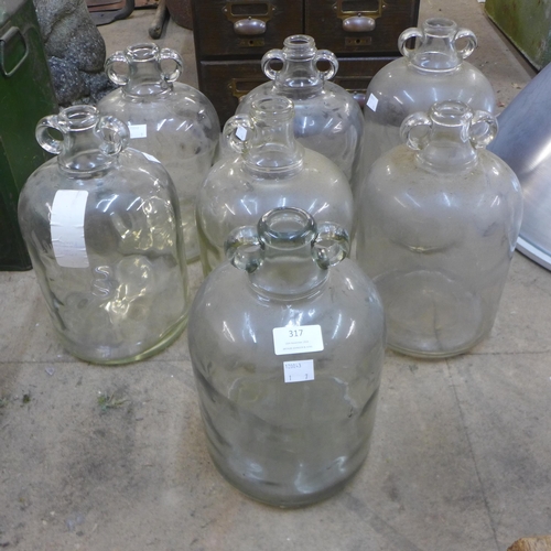 317 - A set of six glass demi-Johns and another