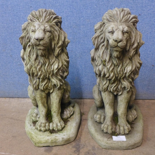 323 - A pair of concrete garden figures of seated lions