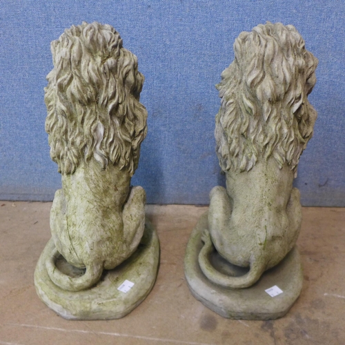 323 - A pair of concrete garden figures of seated lions