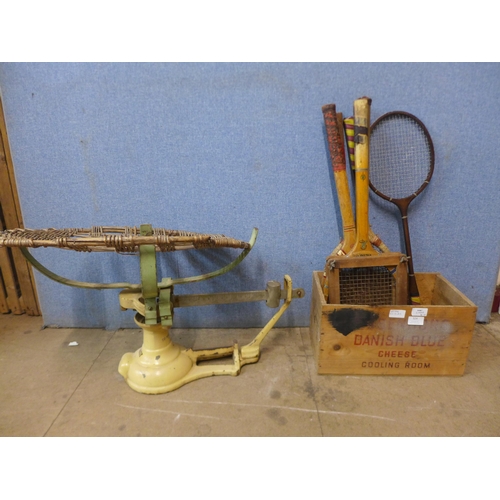 324 - A set of Avery baby weighing scales and a wooden crate with vintage tennis and badminton rackets