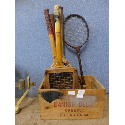 324 - A set of Avery baby weighing scales and a wooden crate with vintage tennis and badminton rackets