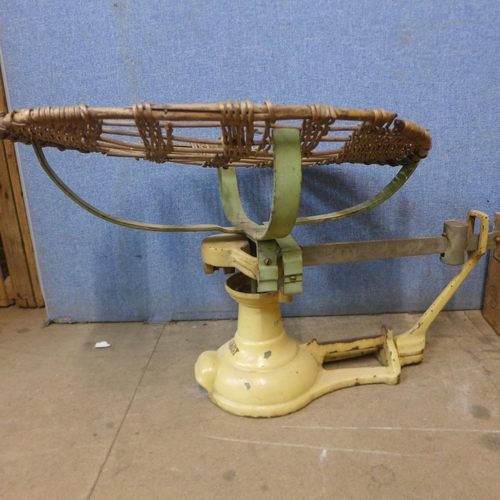 324 - A set of Avery baby weighing scales and a wooden crate with vintage tennis and badminton rackets