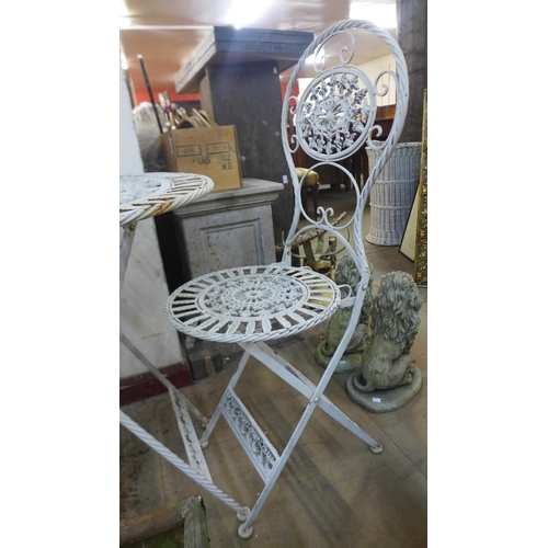 325 - A French style metal folding garden table and two chairs