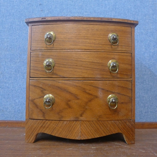 368 - A George III style miniature walnut bow front chest of drawers