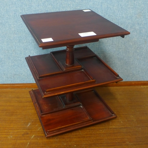 370 - A miniature table top mahogany revolving bookcase