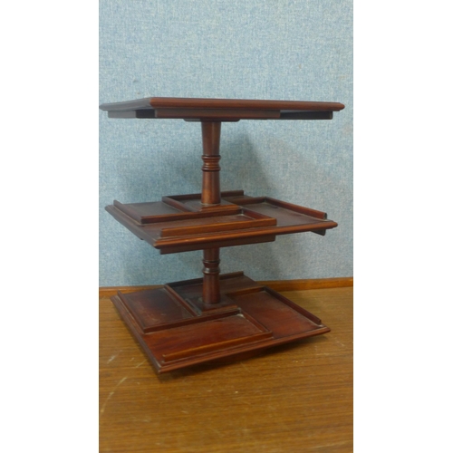 370 - A miniature table top mahogany revolving bookcase