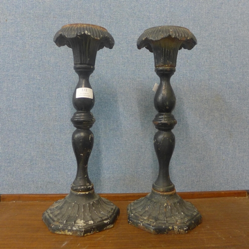 372 - A pair of cast iron ecclesiastical candlesticks