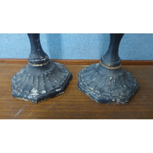 372 - A pair of cast iron ecclesiastical candlesticks