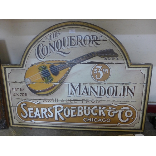 417 - A painted wooden sign; The Conqueror Mandolin