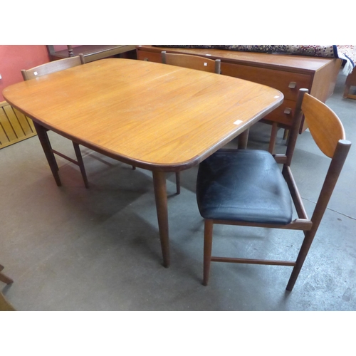42 - A teak extending dining table and three chairs