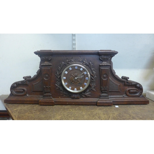 431 - A 19th Century French carved architectural cased oak mantel clock