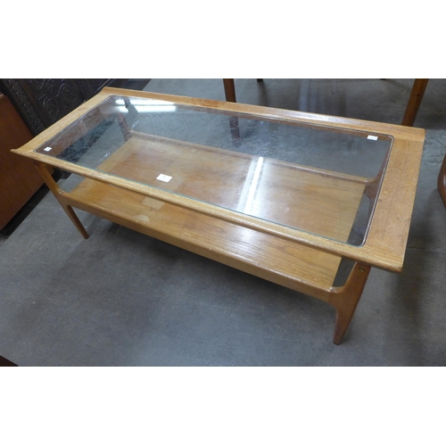 44 - A teak and glass topped rectangular coffee table