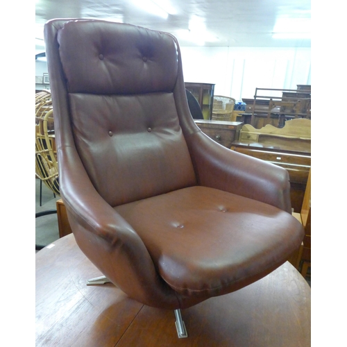 47 - A chrome and burgundy vinyl revolving lounge chair