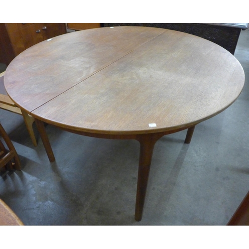 48 - A McIntosh teak circualr extending dining table
