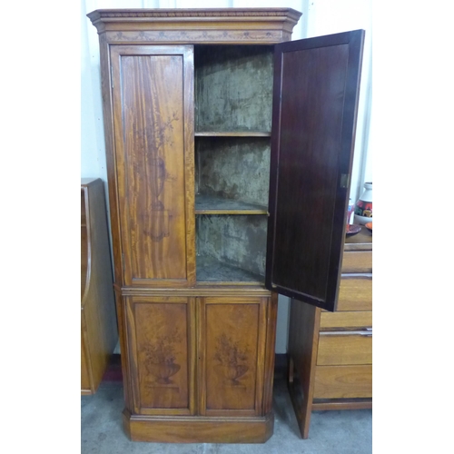 92 - An Edward VII Sheraton Revival painted satinwood splay front freestanding four door corner cabinet