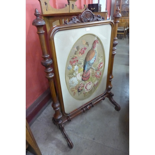 99 - A Victorian carved walnut firescreen, with applique embroidered parrot