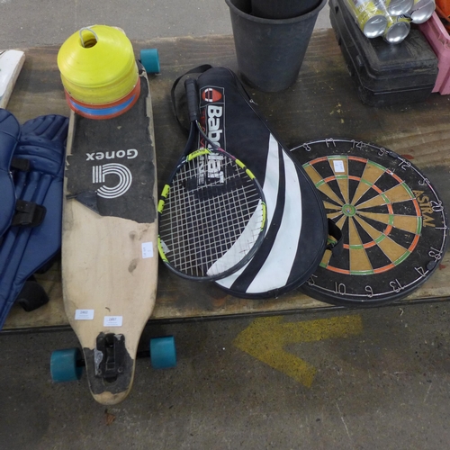 2462 - A large Gonex skateboard, dartboard and squash racket