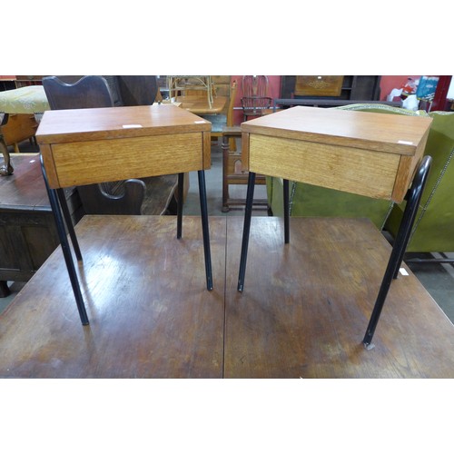 56 - A pair of teak single drawer bedside tables, on black tubular metal stands