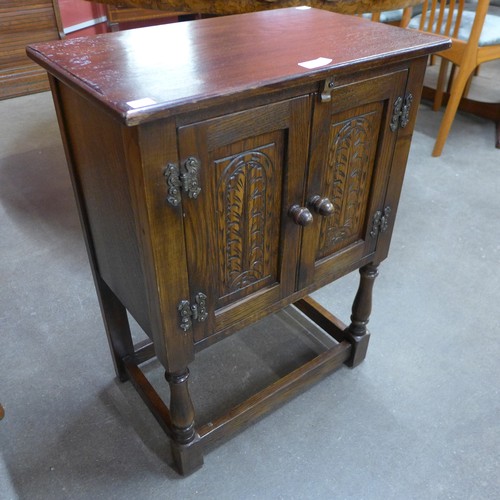 199 - A small carved oak two door cupboard